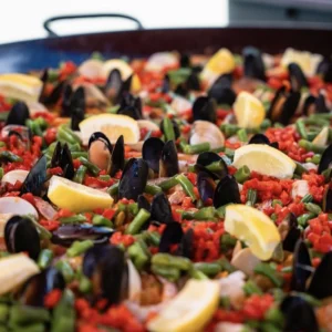 Paella pan filled with mussels, rice, green beans and lemon from The Basque Market in Boise