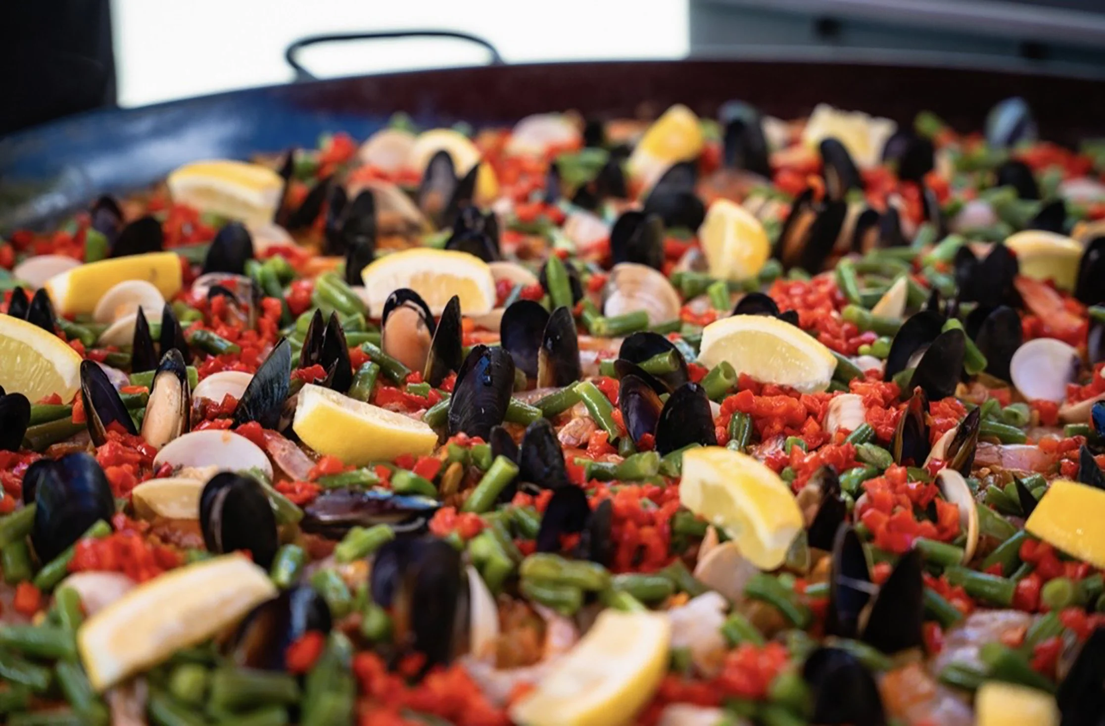 Paella pan filled with mussels, rice, green beans and lemon from The Basque Market in Boise